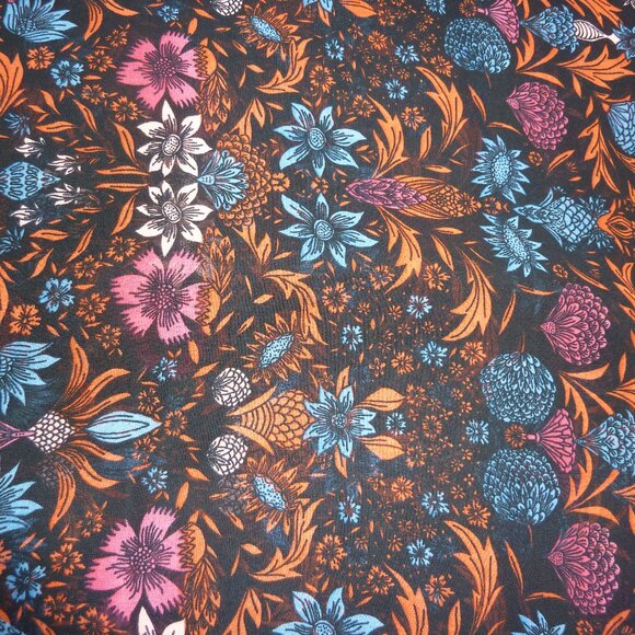 Fabric with blue, orange, red, and pink floral pattern on a black background - Picture 1 of 3